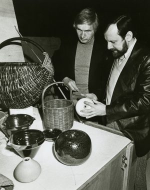 Olaf Harringer (left), exhibits manager at the Museum of Science and Industry in Chicago, and Theodor J. Swigon, assistant exhibits manager, inspect pottery, glassware, textiles, and other pieces from the "Artist-Craftsmen of the Federal Republic of Germany" exhibit.