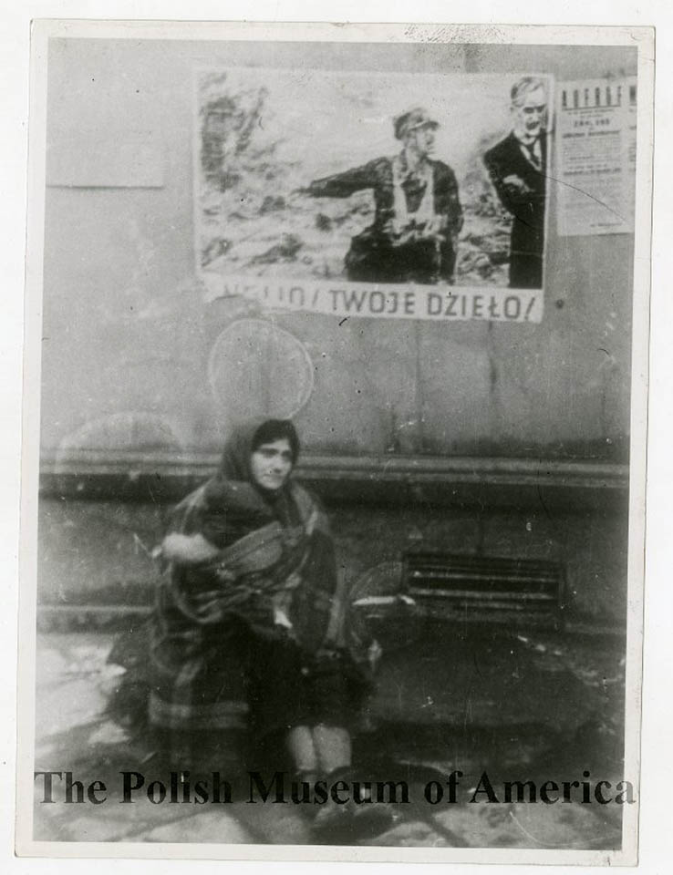 A bundled-up woman sitting on the streets of Warsaw Ghetto, 1939–1941