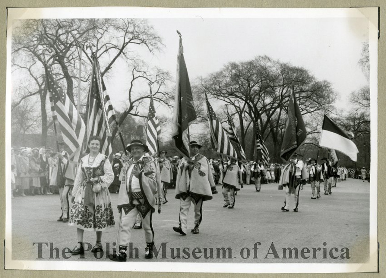May 3rd Parade from 1956; Highlanders marching with flags.
